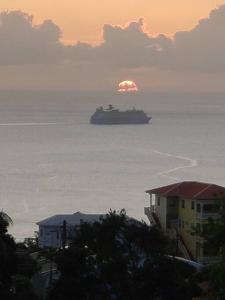 a cruise ship in the ocean with the sunset in the background at SK S Haven #1 in Castries