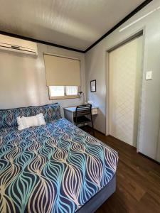 - une chambre avec un lit, un bureau et une fenêtre dans l'établissement Oasis Newman, à Newman