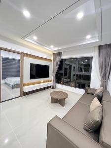 - un salon avec un canapé et une télévision dans l'établissement Beachfront House Nha Trang, à Nha Trang