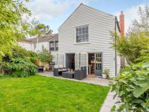an exterior view of a white house with a yard at 3 Bed in Faversham 78880 in Faversham
