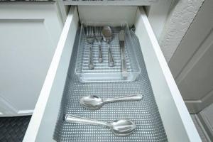 a drawer with spoons and utensils in a cabinet at 2BD/2BA - Walk to *The Battery ATL* w/Free Parking in Atlanta