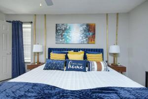 a bedroom with a blue and white bed with pillows at 2BD/2BA - Walk to *The Battery ATL* w/Free Parking in Atlanta