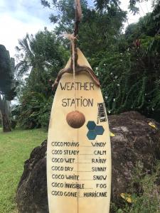 a sign for a weather station on a surfboard at El Toucan Loco floating lodge in Tierra Oscura