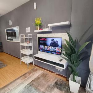 a living room with a flat screen tv on a wall at Fayyadh Homestay Selayang - 3 Bilik 2 Bilik Air -malay only in Batu Caves