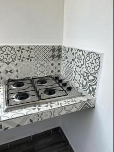a kitchen counter with a stove top in a wall at Departamento Amueblado con Alberca Pedregal C in Tamasopo