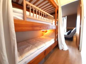 a wooden bunk bed in a room at Studio Saint-Lary-Soulan, 1 pièce, 4 personnes - FR-1-457-338 in Saint-Lary-Soulan