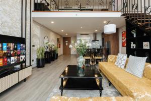 a living room with a couch and a table at Muse Hanoi PentStudio West Lake in Hanoi
