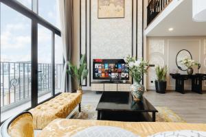 a living room with a couch and a table at Muse Hanoi PentStudio West Lake in Hanoi