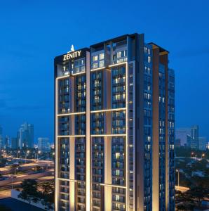 a tall building with a sign on top of it at Luxury 2 or 3BR Apartment in Dist 1, Pool and airport pickup in Ho Chi Minh City