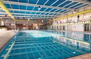 a large swimming pool filled with blue water at NB166 - Porth Bay Hideaway in Newquay Bay Resort