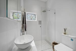 a white bathroom with a sink and a shower at Trefusis Cottage in Blackheath +11 photos