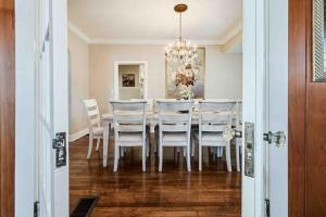 a dining room with a white table and chairs at Beautiful 5BR/4BA Luxury Historic Home on Success in Lakeland