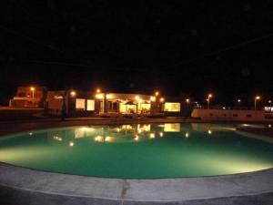 a swimming pool at night with a house in the background at Nuevo Paracas in Paracas