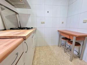 a kitchen with a counter and a table in it at Reina Cristina, 3 dormitorios individuales en Atocha-Retiro in Madrid