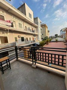 a balcony with a bench in front of a building at The Hub Kampot in Kampot