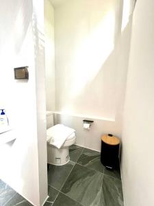 a small bathroom with a toilet in a room at Villa 173 - Two bedroom private villa in Ban Pak Chong Noi