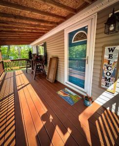 a wooden deck with a bench on a house at Bern's Summit Solitude: Stream-Front Serenity in Confluence