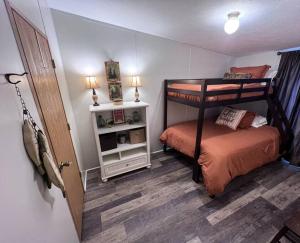 a bedroom with two bunk beds and a small bed at Bern's Summit Solitude: Stream-Front Serenity in Confluence