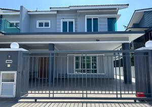 a house with a gate in front of it at Fourteen Homestay in Port Dickson