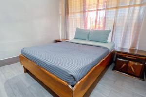 a small bedroom with a bed and a window at Villa Paraíso banano 9, near to the beach & Pool in Jacó +28 photos
