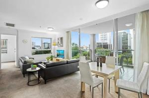 a living room with a couch and a table at Cozy Unit in the heart of Brisbane in Brisbane