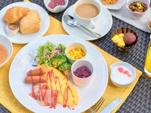 a table with plates of food and a cup of coffee at Osaka View Hotel Honmachi in Osaka