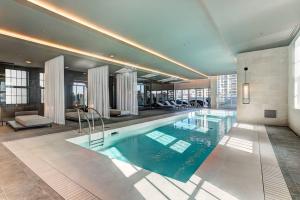 a large swimming pool in a building at Beautiful Downtown condo with Pool and Parking in Montreal