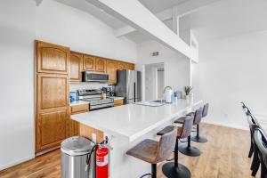 a kitchen with a large white counter and chairs at Spacious Remodeled Retreat Haven in Las Vegas