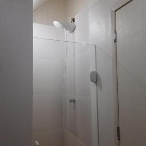 a shower with a glass door in a bathroom at Meu Chalé in Miguel Pereira