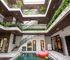 a swimming pool with a pink swan in a building at 9BR villa, 200m from the sea in Da Nang
