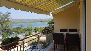 a balcony with a view of the water at Apartments Zvone - at the water front in Veli Rat