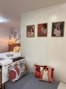 a room with two beds and pictures on the wall at CasaKulot 