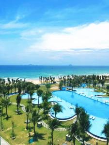an aerial view of a resort with palm trees and the beach at Seaview Hotel - Arena Cam Ranh Resort in Cam Ranh