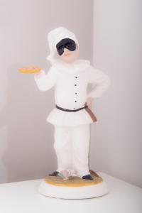 a figurine of a chef holding a spatula at B&B Lungomare in Naples