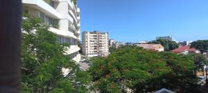 a view of a city with buildings and trees at Cozzy 24 in Maputo