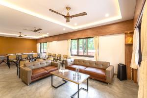 a lobby with couches and tables and a bar at Beach Heaven Villa, Nandgaon in Murud