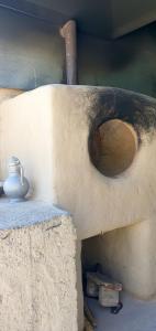 a vase sitting on top of a stone ledge at Kuldosh`s homestay in Majrum village in Madzherum