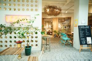 a coffee shop with a bench and a table at LESTEL NAHA in Naha