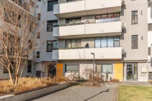 an apartment building with a walkway in front of it at Modern Apollus Avenue - By OpenHouse apartments in Timişoara