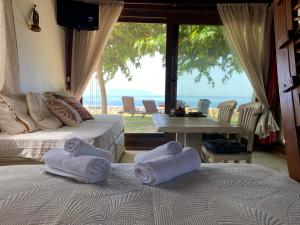 two towels on two beds in a room with a view at Artsy Wooden Cottage in Ratzaklíon