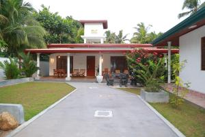 a house with a walkway in front of it at Rupa Villa in Beruwala