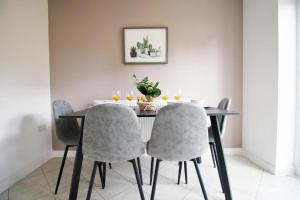 uma sala de jantar com uma mesa e quatro cadeiras em Free Wifi | Parking Access | 3BR em Rogerstone