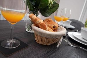 a basket of bread on a table with glasses of wine at Free Wifi | Parking Access | 3BR in Rogerstone
