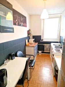 a kitchen with a table and a counter top at Cozy trendy spacious room in green area 12 min. near to the center Alexanderplatz in Berlin