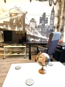 a room with a desk and a tv and a chair at Cozy trendy spacious room in green area 12 min. near to the center Alexanderplatz in Berlin