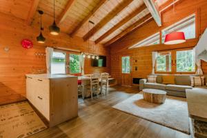 a kitchen and living room in a log cabin at Chalet Soleada - Happy Rentals 