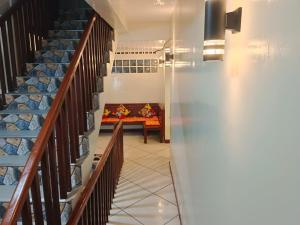 a hallway with stairs with a table in the distance at #1 Green Room Inn Siargao in General Luna