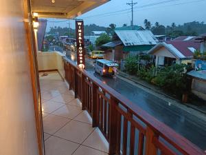 a view of a city street from a balcony at #1 Green Room Inn Siargao in General Luna
