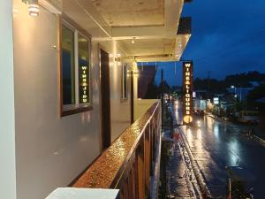 a balcony of a building with a view of a street at #1 Green Room Inn Siargao in General Luna