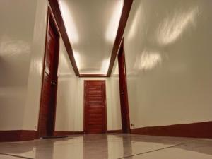 an empty hallway with two doors and a ceiling at #1 Green Room Inn Siargao in General Luna